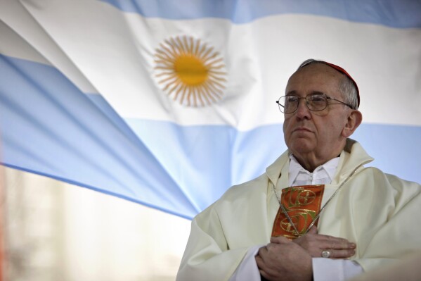 In this Aug. 7, 2009 file photo, Argentina's Cardinal Jorge Bergoglio gives a Mass outside the San Cayetano church where an Argentine flag hangs behind in Buenos Aires, Argentina. (AP Photo/Natacha Pisarenko)
